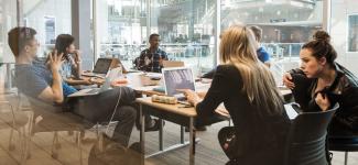 Engineering students in a private room engaging in group discussion