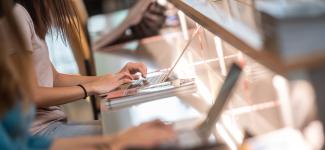 Close up view of a student typing on their laptop